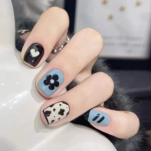 Make a bold statement with this 24 Pcs Press-On Nails Set, featuring short square nails in striking black and blue with fun floral and cow patterns. The glossy finish adds an extra touch of shine, making these nails perfect for both everyday wear and special occasions. Easy to apply and designed for long-lasting wear, this set allows you to achieve a trendy, salon-quality manicure in minutes—no mess, no fuss!