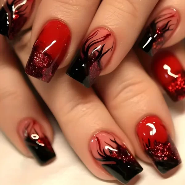 Glossy red press-on nails with flame design for a bold, medium-length manicure.