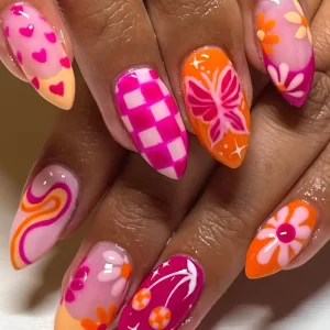 Almond-shaped press-on nails with floral and plant patterns in mixed pink, orange, and yellow tones for a chic look.