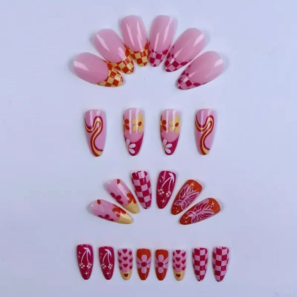 Almond-shaped press-on nails with floral and plant patterns in mixed pink, orange, and yellow tones for a chic look.