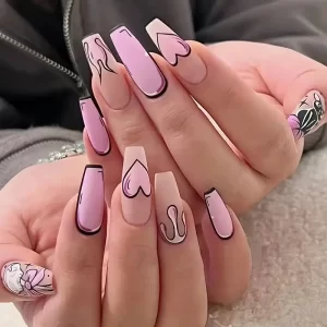 Wearable nail art set with pink and black cartoon-style cat and heart designs.